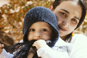 Mother holding cute sweet son photo