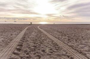 two tracks in the sand on the beach photo