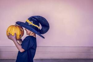 Boy holding halloween pumpkin photo