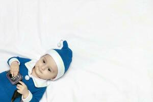 Little Santa. 6-9 months old baby boy in Santa Claus costume. Merry christmas photo