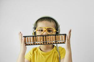 Schoolboy with abacus. Young kid training mental arithmetic photo