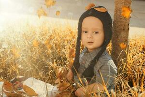 Portrait of 2-3 years old child in autumn garden photo