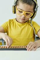 Schoolboy with abacus. Young kid training mental arithmetic photo