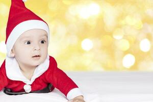 Little Santa. 6-9 months old baby boy in Santa Claus costume. Merry christmas photo