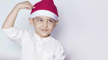 Boy asking are you idiot, are you serious or are you crazy. 6 year boy showing hand gesture. Kid portrait gesturing with fingers against photo