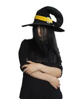 Portrait of young woman in witch costume isolated on white background. Halloween theme on white photo