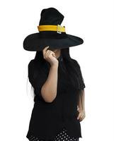 Portrait of young woman in witch costume isolated on white background. Halloween theme on white photo