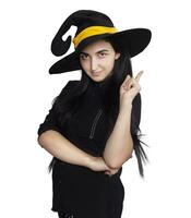 Portrait of young woman in witch costume isolated on white background. Halloween theme on white photo