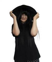 Portrait of young woman in witch costume isolated on white background. Halloween theme on white photo