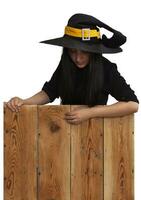 Halloween girl in witch costume on wooden board photo