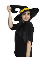 Portrait of young woman in witch costume isolated on white background. Halloween theme on white photo