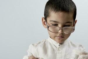 A smart mixed raced boy wearing glasses photo