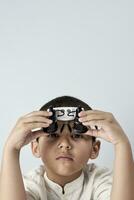 Boy in headband magnifying glass photo