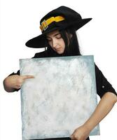 Halloween girl in witch costume holding blank board photo