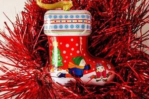 a red tinsel under a christmas stocking ornament photo