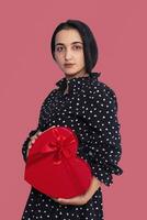 Portrait of young middle-eastern woman with gift box. Romantic giftbox photo