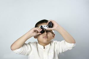 Multiethnic boy in magnifying eyeglasses photo