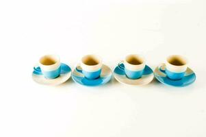 four blue and white coffee cups and saucers photo