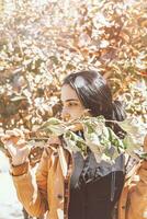 Autumn woman. Fall season concept. A portrait of pretty female with a branch of autumn tree photo