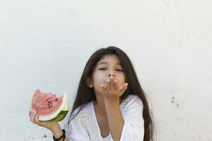 Pre-teen girl eating watermelon. Happy childhood. Summer girl. photo