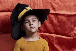 A young kid wearing witch hat photo