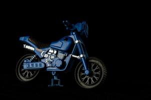 a blue motorcycle is shown against a black background photo