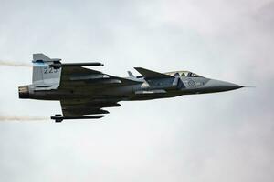 Swedish Air Force SAAB JAS 39 Gripen. Military fighter jet plane at air base. Flight operation. Aviation and aircraft. Air defense. Fly and flying. photo