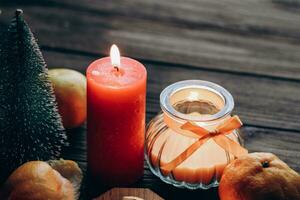 Candles for Christmas decoration, festive attributes and mandarin place for text photo