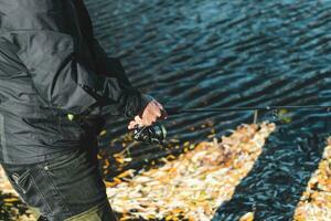 Rubber high boots at the fisherman for fishing, catching fish photo