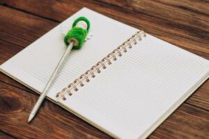 writing pen decorated with a Christmas snowman with a notebook photo