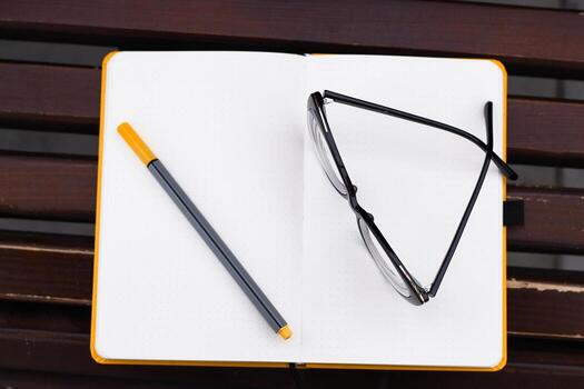 Glasses for vision on a notepad with a marker, study concept photo