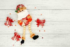 Santa toy for decoration on a white table, place for text photo