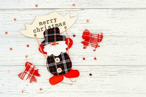 Santa toy for decoration on a white table, place for text photo