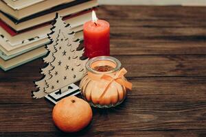 Candles for Christmas decoration, festive attributes and mandarin place for text photo