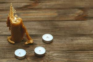 A candle made of natural wax, half burned with paraffin candles. photo