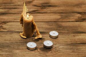A candle made of natural wax, half burned with paraffin candles. photo