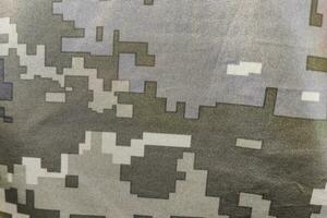textura de cerca píxel camuflaje militar uniforme de el armado efectivo foto