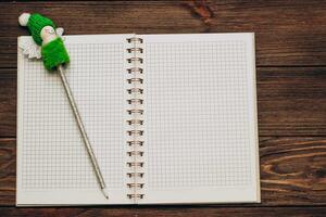 writing pen decorated with a Christmas snowman with a notebook photo