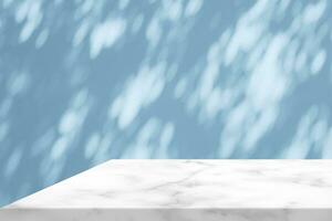 White Marble Table Corner with Light Beam, Shadow, and Spotlight on the Blue Concrete Wall Background, Suitable for Product Presentation Backdrop, Display, and Mock up. photo
