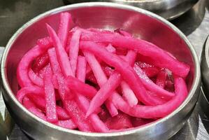 Close up Pink Pickled Turnips. It is one of famous Banchan or Korean Side Dish. photo