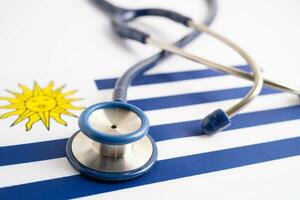 Stethoscope on Uruguay flag background, Business and finance concept. photo