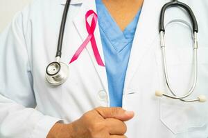 Breast cancer, Asian doctor woman with pink ribbon, symbol of World Breast Cancer Day. photo