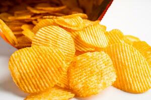 Potato chips, delicious BBQ seasoning spicy for crips, thin slice deep fried snack fast food in open bag. photo