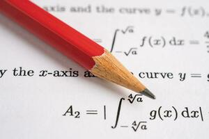 Pencil on mathematic formula exercise test paper in education school. photo