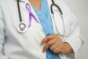 Asian woman doctor with purple ribbon, sign of Alzheimer disease day, Pancreatic cancer, Epilepsy, Lupus. photo