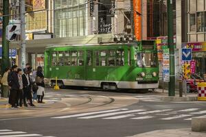 hokkaido japan - octobor 8,2018 old model of supporo city street car ,tram running on track ,sappora is principle city in hokkaido island northern of japan photo