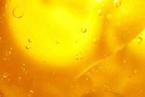 Gold Oil bubbles close up. circles of orange water macro. abstract shiny yellow background photo