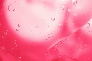 Pink Oil bubbles close up. circles water macro. abstract shiny viva magenta background photo