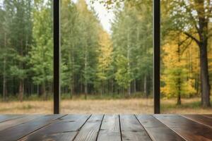 ai generado vacío de madera mesa en frente de ventana con borroso bosque ver antecedentes ai generado foto