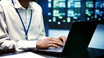 Supervisor mending data center operational issues arising due to high CPU usage, insufficient memory and misconfigured applications. Programmer overseeing server clusters performance trends photo